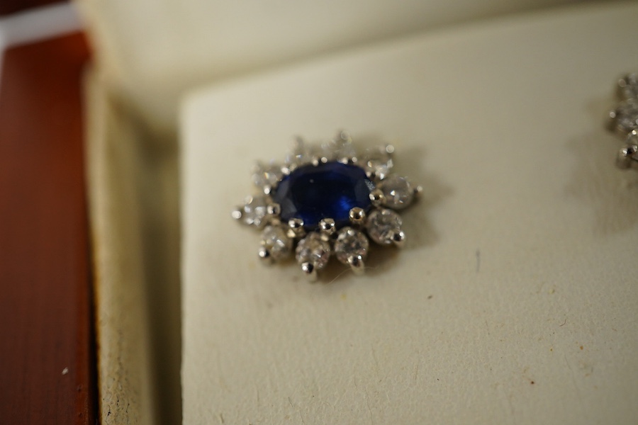 A pair of sapphire and diamond cluster earrings, length 2.2cm each, post fittings, and a gold, garnet and seed pearl pendant, length 4.7cm, stamped 9CT. Condition - good